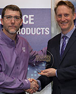 ECD president and CEO, Todd Clifton (pictured right), accepts the Service Excellence Award from Circuits Assembly magazine editor-in-chief, Mike Buetow.